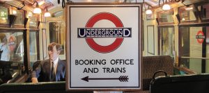 London Underground Booking office sign on background of 1960s Tube train